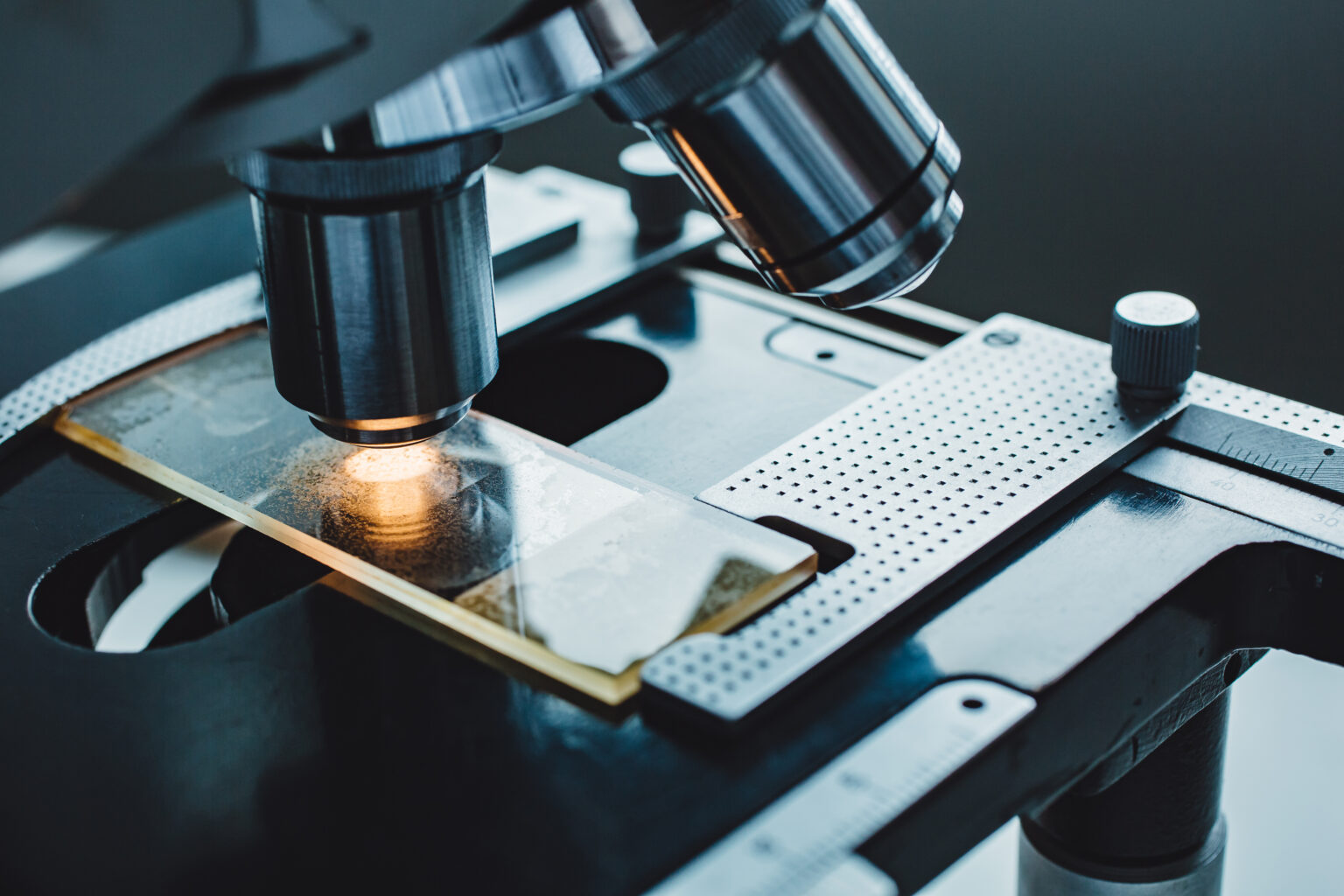 Close-up shot of microscope with metal lens at laboratory.